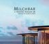 "Milchbar // Seaside Season 18, compiled by Blank & Jones." Moderne Architektur vor Meer und blauem Himmel.