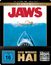 "Jaws", "Der weiße Hai", "4K Ultra HD + Blu-ray", "FSK 16". Illustration eines Hais unter einem schwimmenden Menschen.