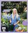 Titel: "Blütenpracht & Ernteglück"; Untertitel: "Dein Weg zum Traumgarten". Eine lächelnde Frau hält eine Gießkanne.