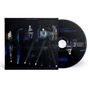 CD und Cover mit dem Text: "as time explodes" und "NEIL YOUNG & THE CHROME HEARTS LIVE ALBUM". Verschwommene Bühnenlichter im Hintergrund., CD