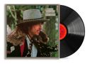 Text: "BOB DYLAN DESIRE". Cover zeigt einen Mann mit Hut und Pelzmantel. Rechts eine schwarze Vinyl-Schallplatte., LP