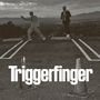 Text "Triggerfinger". Zwei Männer in Anzügen stehen auf einem Parkplatz, einer zeigt mit dem Finger, im Hintergrund Berge., CD