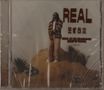"REAL, Blessing Offor" in brauner Schrift. Eine Person steht auf einem sandigen Hügel, trägt eine gestreifte Jacke., CD
