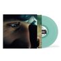 Ein hellgrünes Vinyl mit einer Nahaufnahme eines Gesichts auf dem Cover. Ein Auge schaut interessiert nach vorne., LP
