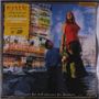 Texte: "mystic", "cuts for luck and scars for freedom", "20th anniversary double LP". 

Eine Frau im roten Top mit Blumen in der Hand, ein Kind schaut zu ihr auf. Hintergrund: Straßenszene mit Autos und Schildern., 2 LPs und 1 Single 7"