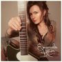 „Emanuela Hutter, Goose Bumps”. Frau mit Gitarre in kariertem Outfit, Nahaufnahme, selbstbewusster Ausdruck., LP