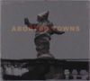 Text: "ABORTED TOWNS". Statue vor trübem Himmel, verhüllte Figur mit ausgebreiteten Armen., CD