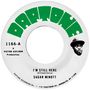 "Daptone" in grün über dem Etikett einer Schallplatte mit den Liedtiteln "I'M STILL HERE" von Sugar Minott. Kopf eines Mannes abgebildet., Single 7"