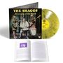 Auf einer Vinylhülle steht "THE SHAGGS Philosophy of the World". Eine gelbe Schallplatte und ein offenes Buch sind ebenfalls sichtbar.