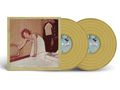Labels: "DISC 1" und "DISC 2".  
Illustration: Frau im weißen Kleid, lehnt sich auf einen Fernseher, im Hintergrund hängt Kleidung.  
Goldene Schallplatten., 2 LPs