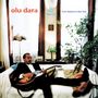 "Olu Dara", "In The World", "From Natchez to New York". Ein Mann mit Gitarre entspannt auf einem Sofa, umgeben von Pflanzen., LP