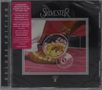 Text: "A BOUNDARY-SMASHING DISCO CLASSIC...". Cover zeigt Cocktailglas auf pinkem Boden, Fuß in elegantem Schuh.