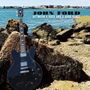 Text: "JOHN FORD BETWEEN A ROCK AND A HARD PLACE." Eine schwarze Gitarre lehnt an Felsen am Meer unter blauem Himmel., 2 CDs