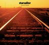 Text: "starsailor love is here". Ein Bahngleis führt in die Ferne unter einem orangefarbenen Himmel.