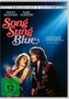Text: "Song Sung Blue" und "FSK ab 12 freigegeben". Zwei Personen singen auf einer Bühne in schillernder Kleidung., DVD