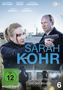 Cover von "SARAH KOHR", FSK 12. Zwei Personen am Hafen mit Waffen, eine blutende Frau im Vordergrund., DVD