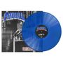 „MADBALL“ und „Side A“ sind in großen Buchstaben zu sehen. Eine blaue Vinyl-Schallplatte liegt teils auf einem Cover., LP