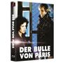 "DER BULLE VON PARIS" in großen Buchstaben, zwei Personen vor einem Maschendrahtzaun, die sich ansehen. Verpackung eines Films.