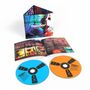 Text: "feeder," "polythene." Zwei CDs, eine blau, eine orange, mit Booklet und Verpackung in buntem, künstlerischem Design., 2 CDs