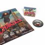 Text "CHAKZILLA". Illustration: Frau, wie Godzilla über Hochhäuser, mit Hubschraubern im Himmel. CD daneben., CD