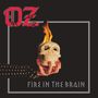 Text: "OZ" und "FIRE IN THE BRAIN". Illustration von Hand hält brennenden Totenkopf, schwarzer Hintergrund., CD