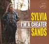 Sylvia Sands, I'm a Cheater. Frau in Lederjacke lehnt an Baum. Hintergrund ist ein Wald mit Wasser.