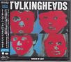 Der Text oben lautet "TALKING HEADS" und unten "REMAIN IN LIGHT". Vier Gesichter mit pixelig-rotem Effekt sind dargestellt.