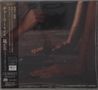 Vertikaler Text links auf Japanisch, im Schatten davon Hände auf einer dunklen Oberfläche und ein Mikrofon., CD