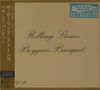 "Rolling Stones Beggars Banquet" in geschwungener Schrift, umgeben von japanischen und englischen Texten, schlichtes Design.