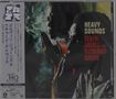 "HEAVY SOUNDS" steht in weißer und roter Schrift. Zwei Menschen, einer raucht, in gedämpftem Licht. Jazz-Atmosphäre., CD