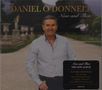 "Daniel O'Donnell Now and Then" Albumcover mit einem Mann in hellem Hemd auf einem Gartenweg, umgeben von Statuen., CD