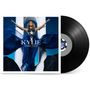 „KYLIE APHRODITE“ steht auf einem Albumcover mit einer Person, die ein blaues Kleid trägt, die Arme ausgebreitet. Eine Schallplatte ist daneben., LP