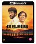 "THE KILLING FIELDS" in schwarzer Schrift vor Sonnenuntergang, zwei Männer im Vordergrund, Soldaten im Hintergrund., Ultra HD Blu-ray