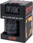 „AC/DC MUG AND SOCKS SET“. Schwarze Tasse mit „AC/DC BACK IN BLACK“-Aufdruck in einem schwarzen Karton mit rotem „AC/DC“-Logo.