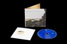 "Polygon Window (Surfing on Sine Waves)" steht auf dem CD-Cover. Sie zeigt eine Küste mit Felsen und Meer. Eine CD liegt daneben., CD