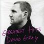 "Greatest Hits David Gray" steht in lila Schrift. Schwarzweißes Profil eines Mannes mit kurzem Haar und Bart., CD
