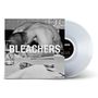 Text: BLEACHERS. Ein Schwarz-Weiß-Bild zeigt einen gebeugten Oberkörper an einem Tisch mit Gläsern und Besteck. Klare Vinyl-Schallplatte., LP