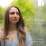 Texte: "Lucy Walker Choral Works", "St Martin’s Voices", "Andrew Earis". Eine Frau mit langen Haaren vor unscharfem grünem Hintergrund., CD