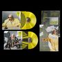 Zwei gelbe Schallplatten mit Hüllen. Cover zeigen Person in auffälligem Outfit mit Brille. Texte: „DIGITiSE“, „Humanize“., LP