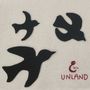 Text "UNLAND" und "Saint", drei schwarze Vogelsilhouetten auf hellem Hintergrund., CD