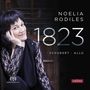 Texte: Noelia Rodiles, 1823, Schubert · Allú, super audio CD, eudora. Frau sitzt entspannt, lächelt, trägt Spitzenshirt., Super Audio CD