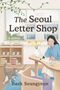 „The Seoul Letter Shop“ und „Baek Seungyeon“. Eine Frau schreibt an einem Tisch, daneben ein Regal, eine Katze und Pflanzen., Buch