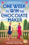 „One Week to Win the Chocolate Maker“. Zwei Männer auf einer Terrasse mit Hügeln im Hintergrund, ein offenes Ringetui.