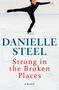 „DANIELLE STEEL, Strong in the Broken Places, a novel“. Eiskunstläuferin in schwarzem Outfit auf Eisfläche in Pirouette., Buch