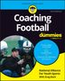 „Coaching Football for dummies“ auf einem Buchcover mit Mann, der einen jungen Spieler coacht., Buch