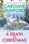 Titel: "A Death at Christmas". Ein winterliches Haus inmitten verschneiter Bäume, von Mistelzweigen umrahmt., Buch