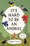 "IT'S HARD TO BE AN ANIMAL" und "ROBERT ISAACS" in großen Buchstaben. Tiere und Stadtsilhouette im Hintergrund.