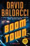 DAVID BALDACCI, BOOM TOWN, A THRILLER. Großstadt bei Nacht mit grellen Lichtern und starkem Gelb-Orange-Kontrast.