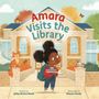 "Amara Visits the Library" steht oben. Ein Mädchen mit Büchern, eine Katze und Taube vor einer Bibliothek.