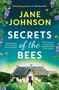 "Jane Johnson: Secrets of the Bees". Farbige Blütenmuster und Bienen umgeben ein Landhaus mit Strohdach und Garten.